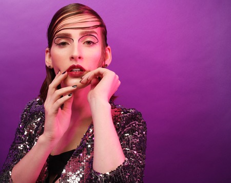 fashion model posing over purple backgroundの写真素材