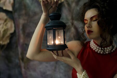 Portrait of beautiful young woman with candleの写真素材