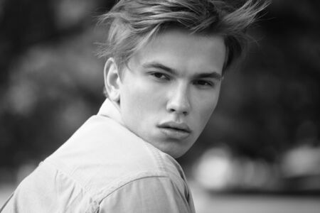 stylish man portrait in summer park.の写真素材