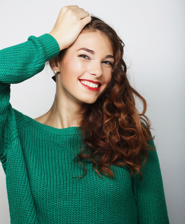 pretty young blond woman with curly hairの写真素材