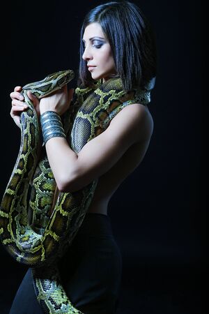 sexy brunette holding pythonの写真素材