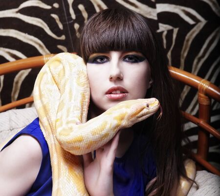 woman holding yellow Pythonの写真素材
