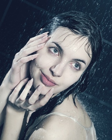 young curly woman with waterの写真素材