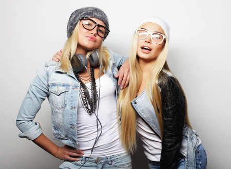 lifestyle and people concept: Two young girl friends standing to