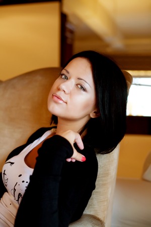 woman sitting and  smiling indoors