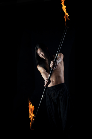 asian man with fire show