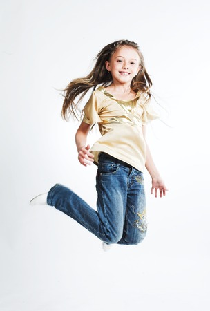 little girl jump over white backgroundの写真素材