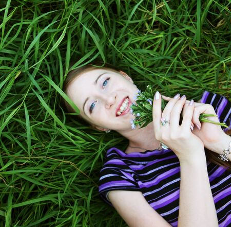 young smiling woman on the grass