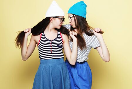 lifestyle and people concept: Two girl friends standing togetherの写真素材