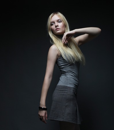 Portrait of beautiful young blonde girl in black dress.の写真素材
