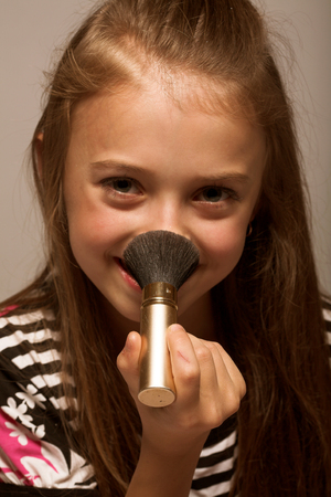 little girl with cosmeticsの写真素材