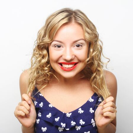Beautiful young surprised woman. Studio shot.の写真素材
