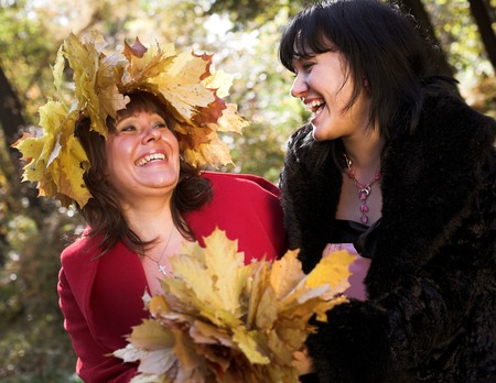 two women in autumnal parkの写真素材