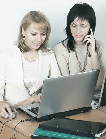 Two business woman working on laptopの写真素材