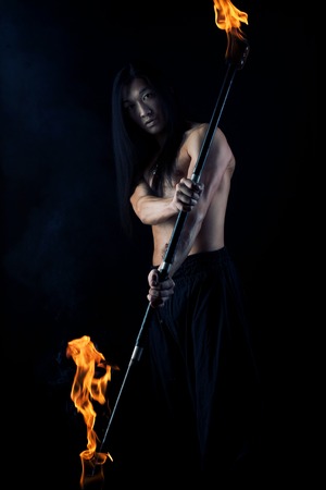 asian man with fire show