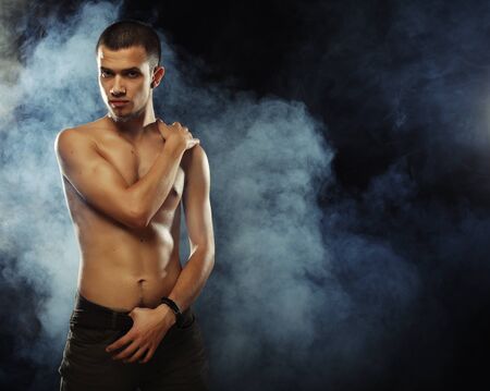 Portrait of a muscular male model against dark  background withの写真素材