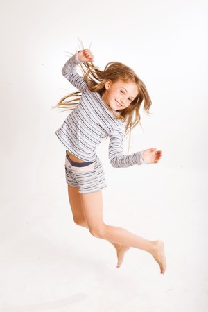 girl jumps on a white backgroundの写真素材