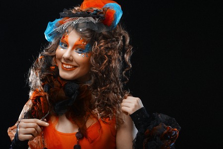 Girl with with creative make-up holds lollipop. Doll style.の写真素材