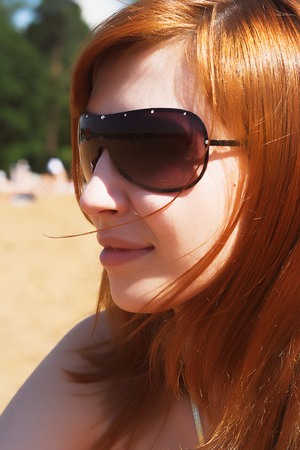 beautiful sexy red womani laying on sea beachの写真素材