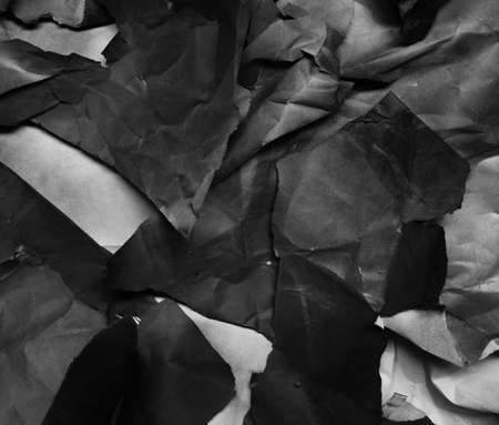 background of fragments of crumpled paper, black and whiteの写真素材