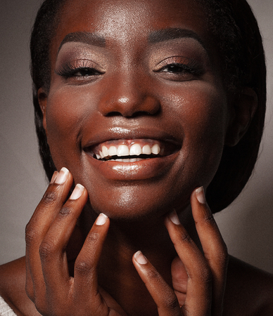 life style and people concept: Close up portrait of confident african american woman laughingの写真素材