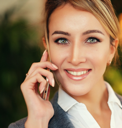 technology, communication and people concept - happy woman calliの写真素材