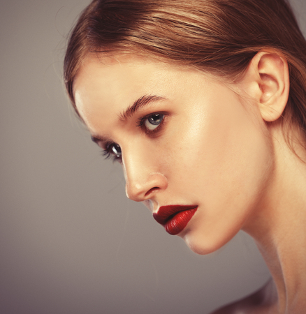 Beauty face of young woman, red lips make-up, clean skin.の写真素材