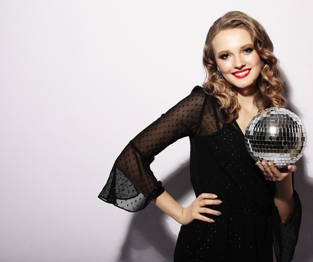 Beautiful young sensual woman wearing black dress and holding diの写真素材