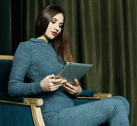 lifestyle, people and tehnology concept: beautiful woman at home working with a tabletの写真素材