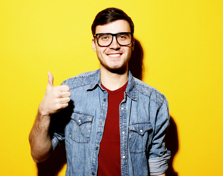 Portrait of a cheerful young man showing okayの写真素材