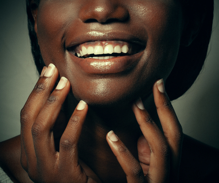 Close up portrait of beautiful young black woman laughing