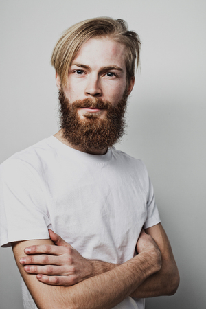 Lifestyle and people concept: Bearded man with his arms crossedの写真素材