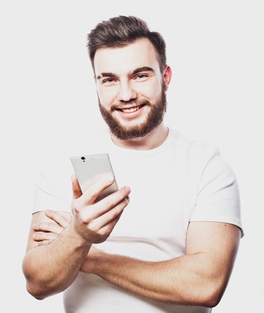 Tehnology and people concept: Bearded man  typing sms on white  backgroundの写真素材