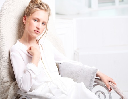 Girl fashion portrait. Child model sitting in chair.の写真素材