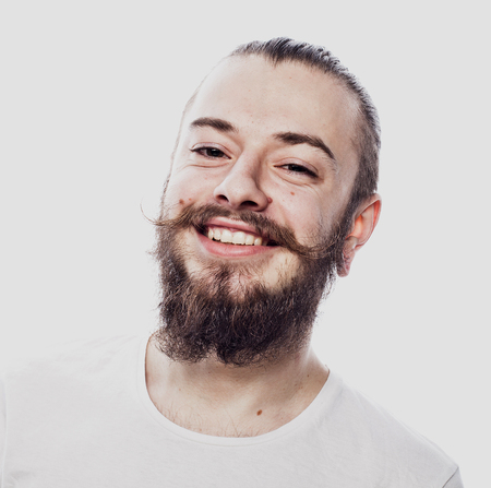 Lifestyle and people concept: Closeup portrait of a happy young man smiling on white  backgroundの写真素材