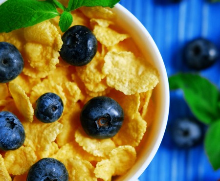 Healthy eating, food  and diet concept - Cornflakes with berries