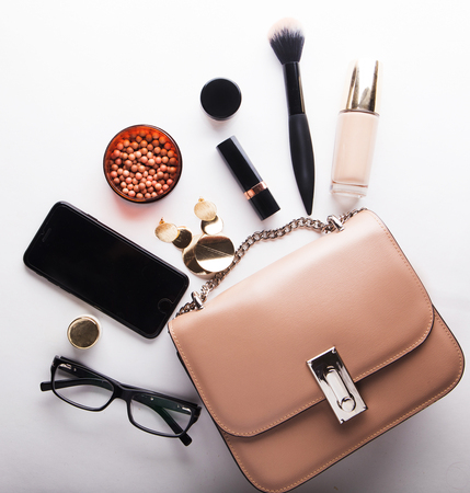 Flat lay of female fashion accessories and pink  handbag on white  background with copyspaceの写真素材