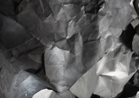 monochrome background of torn pieces of black and white paperの写真素材