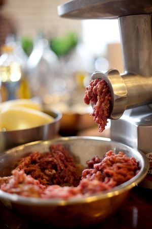 front part of meat grinder or mincing-machine with mincemeat in. Showing the forcemeat process.の写真素材