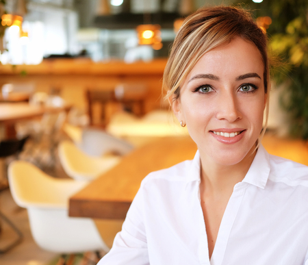 Beautiful businesswoman at the co-working smiling.の写真素材