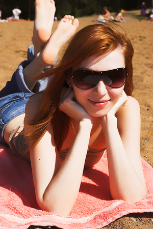 beautiful sexy red womani laying on sea beachの写真素材