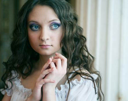 Beautiful young Victorian lady in white dressの写真素材