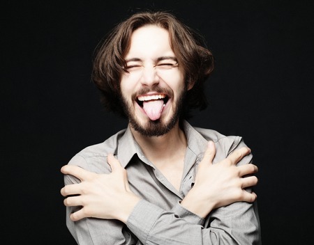 lifestyle and people concept:young man has excited expression, dresssed casuallyの写真素材