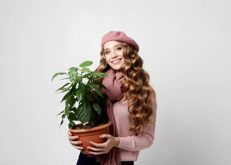 lifestyle, emotion and people concept: Beautiful girl with long wavy hair holding a flowerの写真素材