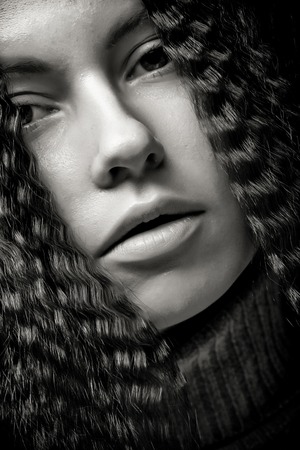 Portrait of pretty young woman with curly hair
