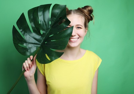 lifestyle and people concept: young woman with a leafの写真素材