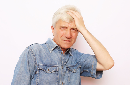 lifestyle, health and people concept: Senior man has headache, on white backgroundの写真素材