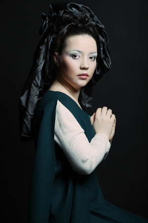 Woman with long hair in historical medieval green  dressの写真素材