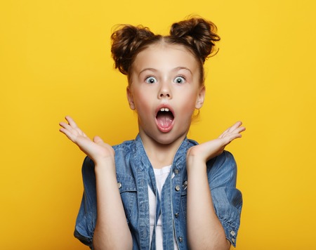 Portrait of little girl  with opened mouth and crazy expression.の写真素材