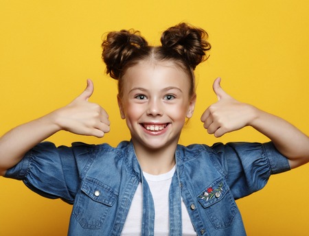 Portrait of a beautiful and confident girl showing thumbs upの写真素材